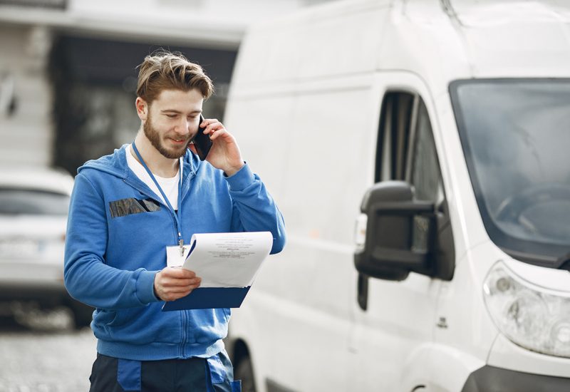 Delivery man with package outdoors